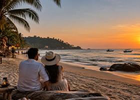 A couple watching the sunset from a Goa beach shack